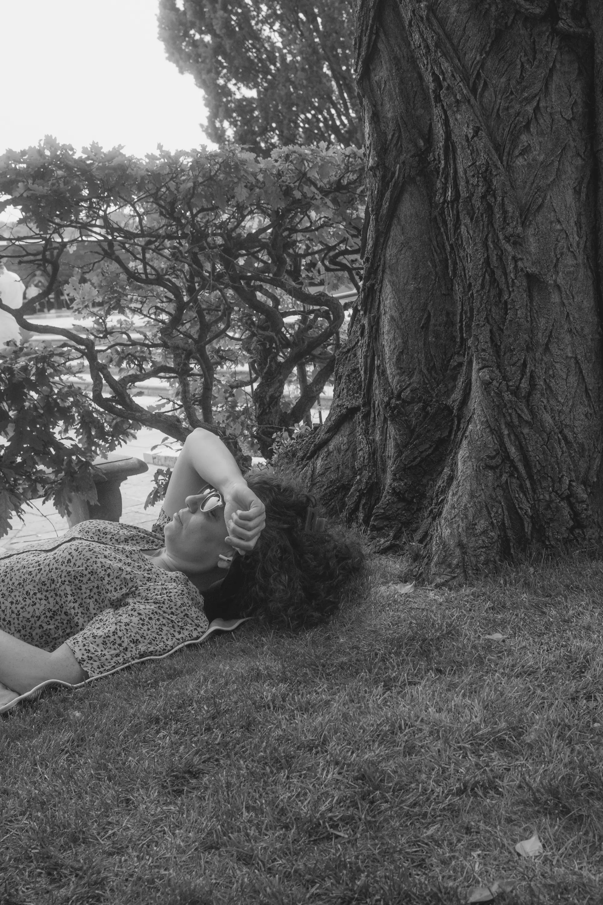 A woman lying on the floor, enjoying the summer sun